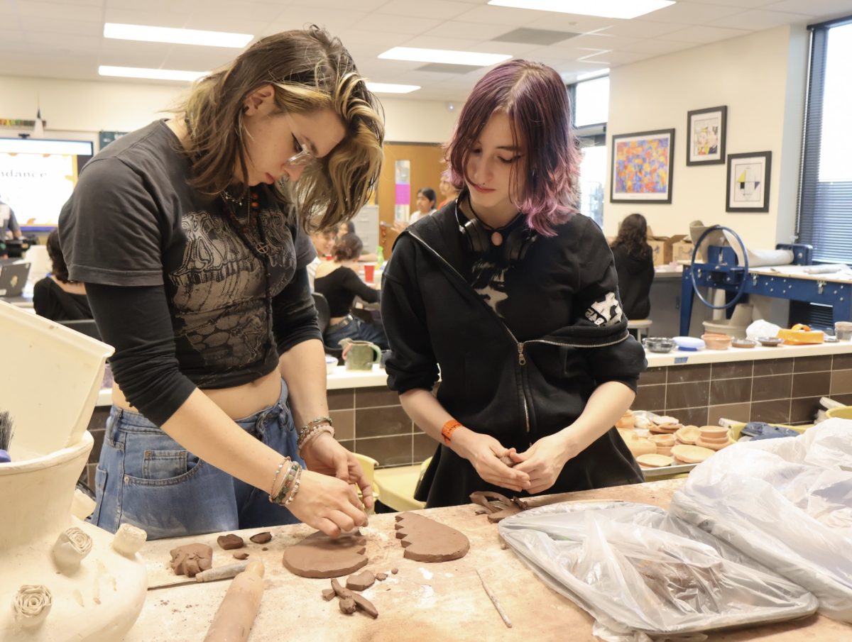 Guiding Legend Galvan ‘25 on sculpting techniques, Ollie Trail '25 works on their friendship trays in the shape of a broken heart. Both friends decided to join the Ceramics Club as it was a great opportunity to learn and harness their love for ceramics together. “One day I was hanging out with Legend and thought of a genius idea to make a heart-shaped tray out of clay, and once I found out Ceramics Club was having a meeting, we took it as the perfect activity to create what we had in mind,” Trail said.